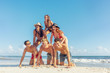 Human pyramid with young friends at the beach