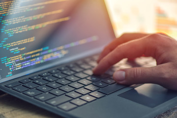 Closeup coding on screen, hands coding html and programming on screen laptop, web development, developer