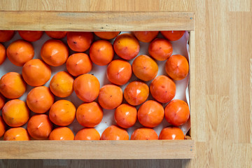 Wall Mural - fresh persimmon wooden crate top view b