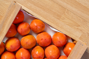 Wall Mural - fresh persimmon wooden crate top view b