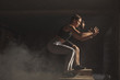 © alfa27 - Muscular guy and sports girl in the gym training . Naked press, inflated muscles during functional workout in modern crossfit centre.