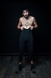 © Evgeny Leontiev - A young man in his pants on a black background