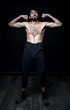 © Evgeny Leontiev - A young man in his pants on a black background