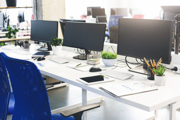 Modern coworking open space interior with computers