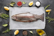 Delicious trout with herbs, spices on grey background. Healthy food. Cooking concept.