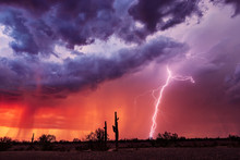 Lightning Bolt Strikes From A Storm At Sunset.