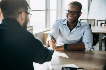 handshake business team smile African American caucasian