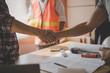 © Pormezz - Successful deal, male architect shaking hands with client in construction site after confirm blueprint for renovate building.