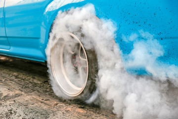 Wall Mural - Drag racing car burns rubber off its tires in preparation for the race