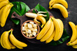 canvas print picture - Bananas on a black wooden surface. Tropical Fruits. Top view. Free copy space.