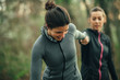 © GAGO IMAGES - Two young beautiful woman exercise in the forest