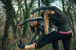 © GAGO IMAGES - Two young beautiful woman exercise in the forest