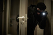 © Kadmy - Burglar thief in mask. break-in of an apartment.