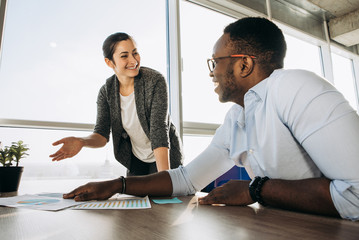 Poster - Colleagues, modern guy and girl communicate with each other in their office