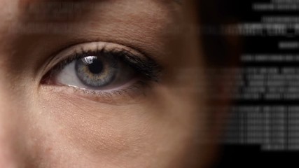 Caucasian female with tanned skin and grey eyes using artificial intelligence to analysed program code running on holographic interface. Futuristic technology digital animation. Eye close up