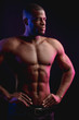 © alfa27 - African male athlete with naked torso with six pack posing against dark wall. Low key photo.