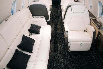 Wall Mural - Business jet plane interior with leather seats and sofa