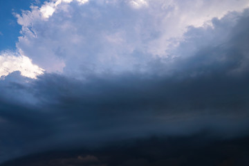 Wall Mural - Scary epic sky with menacing clouds. Hurricane wind with a thunderstorm. Stock background, photo