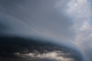 Wall Mural - Scary epic sky with menacing clouds. Hurricane wind with a thunderstorm. Stock background, photo