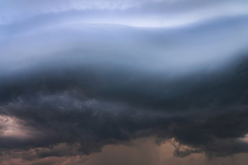 Wall Mural - Scary epic sky with menacing clouds. Hurricane wind with a thunderstorm. Stock background, photo