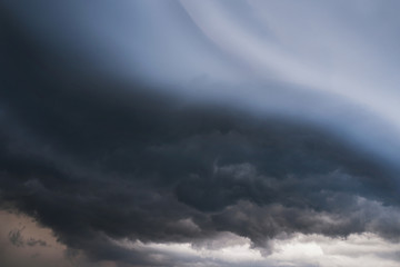 Wall Mural - Scary epic sky with menacing clouds. Hurricane wind with a thunderstorm. Stock background, photo