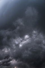 Wall Mural - Scary epic sky with menacing clouds. Hurricane wind with a thunderstorm. Stock background, photo