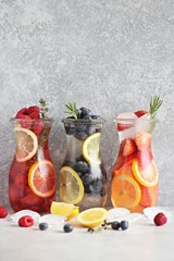 Wall Mural - Berry infused water, coctail, lemonade or tea. Summer iced cold drinks with strawberry, blueberry, raspberry, lemon and herbs Selective focus