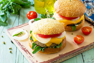 Arabic cuisine, Ramadan food. Delicious fresh Big sandwich - hamburger burger with vegetarian mung cutlets burger on a wooden kitchen table. Copy space.