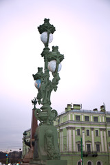 Wall Mural - old metal lantern on a bridge over the river