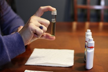 Person testing water pH balance for fish tank.