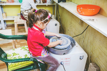 Wall Mural - Child Learning New Skill At Pottery Workshop