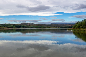  Overcast sky reflections on Pantano de la Grajera or La Grajera Reservoir surface on the Way of St. James, Camino de Santiago near Logrono, La Rioja, Spain