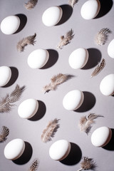 Wall Mural - Easter background. Easter egg composition of white eggs and feathers.