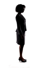 Silhouette of a black businesswoman or an anonymous female presidential candidate.  The person is backlit and isolated on a white background.