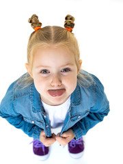 Little girl shows tongue.