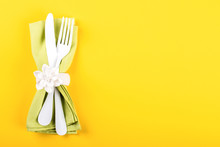 Spring Table Setting On A Bright Yellow Background.Holiday Decoration.Happy Easter Concept. Top View. Flat Lay.Copy Space For Text.