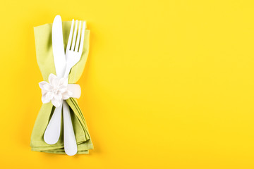 Spring table setting on a bright yellow background.Holiday decoration.Happy Easter concept. Top View. Flat Lay.Copy space for Text.