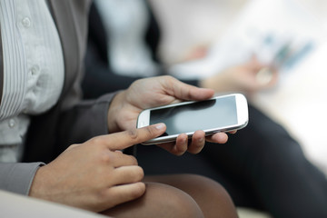 Wall Mural - close up.business woman presses the screen of the smartphone