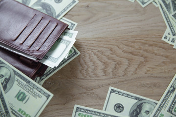 close up.wallet and dollar bills on wooden background.business concept