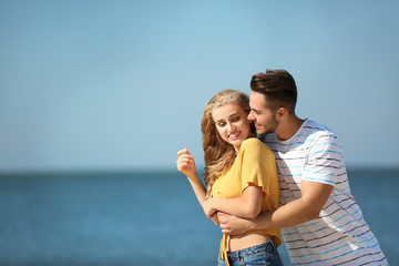 Canvas Print - Happy young couple at beach on sunny day