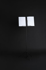 Poster - Note stand with music sheets on black background