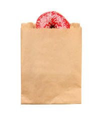 Paper bag with donut on white background, top view. Space for design