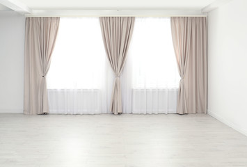 Poster - Windows with elegant curtains in empty room