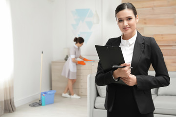 Canvas Print - Housekeeping manager checking maid work in hotel room