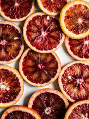 Wall Mural - Raw blood red orange slice on a light background. Citrus background,