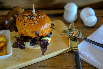 Wall Mural - Cheeseburger on old wooden 