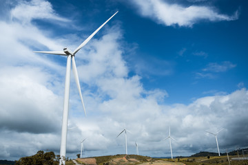 Wind turbines generating electricity with blue sky