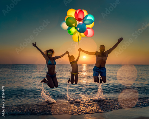 Happy family jumping in the sea