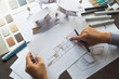 © Chaosamran_Studio - architect design working drawing sketch plans blueprints and making architectural construction model in architect studio