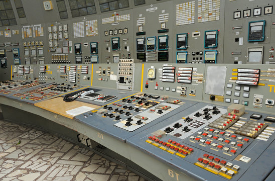 operator sits in front of the main control board in a control operations room of the reactor of the 